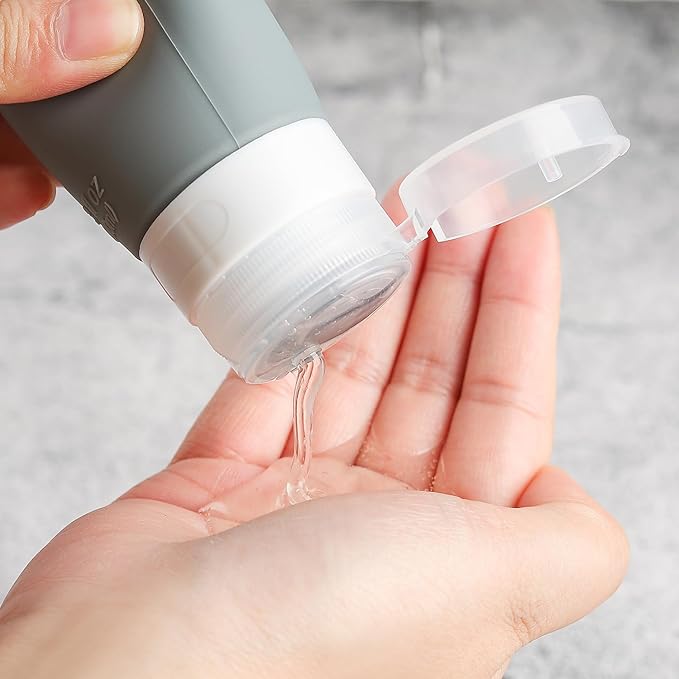 Travel Bottles Kit (16 Pack) - TSA Approved, Leak Proof Silicone Squeezable Containers for Toiletries. Complete Set with Jars, Sprayers & Bag (Black)